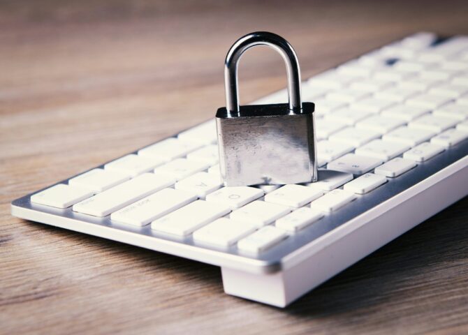 a computer keyboard with a padlock on top of it