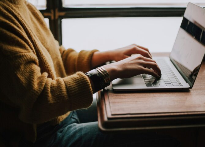 person sitting front of laptop