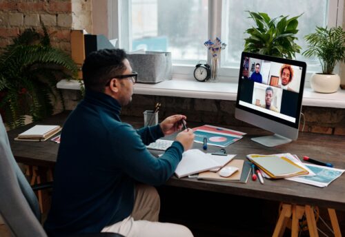 teacher-video-calling-with-his-students-using-a-computer